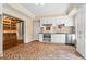 Kitchen with stainless steel appliances, white cabinets, laminate floors, and built-in shelving nearby at 1000 Gunter Ct, Alpharetta, GA 30022