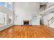 Open living room with a fireplace, built-in shelves, and hardwood floors at 1000 Gunter Ct, Alpharetta, GA 30022