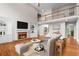 Bright living room with a fireplace, hardwood floors, and a balcony overlooking the space at 1000 Gunter Ct, Alpharetta, GA 30022