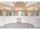 Large primary bathroom featuring dual vanities, white cabinetry, and great mirrors at 1000 Gunter Ct, Alpharetta, GA 30022