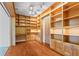 Home office with built-in shelving, wood floors, recessed lighting, and a ceiling fan at 1000 Gunter Ct, Alpharetta, GA 30022