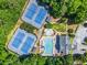 Overhead view of community tennis courts, pool and clubhouse surrounded by trees at 1000 Gunter Ct, Alpharetta, GA 30022