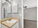 Bathroom with single sink vanity, mirror, and open bedroom access at 1234 Wellhouse Walk, Stone Mountain, GA 30088