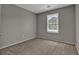 Neutral bedroom featuring carpet floors, a window, and gray walls at 1234 Wellhouse Walk, Stone Mountain, GA 30088