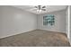 Carpeted bedroom features a ceiling fan and natural light at 1234 Wellhouse Walk, Stone Mountain, GA 30088