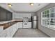 Traditional kitchen features white appliances, cabinets, and tile flooring, along with lots of natural light at 1234 Wellhouse Walk, Stone Mountain, GA 30088