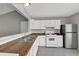 Efficient kitchen offering ample counter space, tiled flooring, and stainless steel refrigerator at 1234 Wellhouse Walk, Stone Mountain, GA 30088