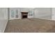 Carpeted living room with brick fireplace and French doors to the backyard at 1234 Wellhouse Walk, Stone Mountain, GA 30088
