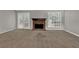 Carpeted living room with brick fireplace and French doors to the backyard at 1234 Wellhouse Walk, Stone Mountain, GA 30088