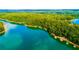 An aerial view showcases the serene lake with various private docks and wooded shorelines in the neighborhood at 2540 Ridgehurst Dr, Buford, GA 30518