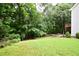 View of the yard backing up to lush trees, providing a private outdoor space at 2540 Ridgehurst Dr, Buford, GA 30518