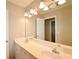Bathroom featuring double vanity and a large mirror, with a doorway to an adjoining room at 2540 Ridgehurst Dr, Buford, GA 30518