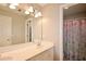 Bathroom features a double vanity and a large mirror, with a doorway to the shower at 2540 Ridgehurst Dr, Buford, GA 30518