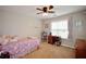 Comfortable bedroom with plush carpet, ceiling fan, and window with natural light at 2540 Ridgehurst Dr, Buford, GA 30518