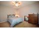 Cozy bedroom features carpet, ceiling fan, dresser, and natural light from a window at 2540 Ridgehurst Dr, Buford, GA 30518