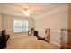 Large bedroom with plush carpet, ceiling fan, and window with bright natural light at 2540 Ridgehurst Dr, Buford, GA 30518