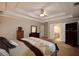 Spacious bedroom features a tray ceiling, ceiling fan, and doorway to the en-suite bathroom at 2540 Ridgehurst Dr, Buford, GA 30518
