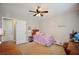 Bedroom features a ceiling fan and a window providing natural light at 2540 Ridgehurst Dr, Buford, GA 30518