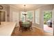 Bright breakfast nook features a round table, chandelier lighting, and door access to the outside deck at 2540 Ridgehurst Dr, Buford, GA 30518