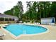 Community pool with a covered area and an ample amount of lounging chairs at 2540 Ridgehurst Dr, Buford, GA 30518