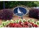 Stone community sign with colorful flowers and bushes around it, adding curb appeal at 2540 Ridgehurst Dr, Buford, GA 30518