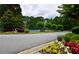Street view of the community sign with the tennis courts in the background, adding to the appeal at 2540 Ridgehurst Dr, Buford, GA 30518