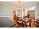Bright dining room features wood floors, a chandelier, and is open to other areas of the home at 2540 Ridgehurst Dr, Buford, GA 30518
