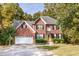 Two-story brick home featuring well-maintained landscaping, a two-car garage, and a traditional facade at 2540 Ridgehurst Dr, Buford, GA 30518