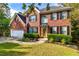 Beautiful two-story brick home with a manicured lawn, tasteful landscaping, and an attached two-car garage at 2540 Ridgehurst Dr, Buford, GA 30518