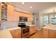 Bright kitchen showcases light wood cabinets, stainless steel appliances, and modern finishes at 2540 Ridgehurst Dr, Buford, GA 30518