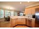 Well-lit kitchen with stainless steel appliances, light wood cabinets, and a view to the breakfast area at 2540 Ridgehurst Dr, Buford, GA 30518