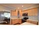 Kitchen with stainless steel appliances, light wood cabinets, and a tile backsplash at 2540 Ridgehurst Dr, Buford, GA 30518