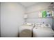 Bright laundry room featuring white appliances and ample shelving space at 2540 Ridgehurst Dr, Buford, GA 30518