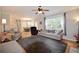 Open concept living room with hardwood floors, neutral paint, and natural light from large windows at 2540 Ridgehurst Dr, Buford, GA 30518
