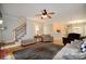 Open concept living room features stairs to upper level, hardwood floors, and view to kitchen at 2540 Ridgehurst Dr, Buford, GA 30518