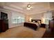 Spacious main bedroom with trey ceiling, fan, carpet, and natural light from large window at 2540 Ridgehurst Dr, Buford, GA 30518