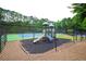 View of the playground and tennis courts enclosed by a chain link fence, creating a safe and fun amenity at 2540 Ridgehurst Dr, Buford, GA 30518