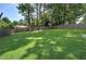 Grassy backyard with mature trees and wood privacy fence at 2646 Rockcliff Road Se, Atlanta, GA 30316