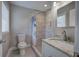 Updated bathroom featuring modern vanity, granite countertop, and a tiled shower with glass doors at 2646 Rockcliff Road Se, Atlanta, GA 30316