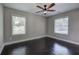 Neutral bedroom with wood floor, white trim, and a ceiling fan with plenty of natural light at 2646 Rockcliff Road Se, Atlanta, GA 30316