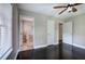 Neutral bedroom with wood floor, white trim, ceiling fan, and access to the bathroom at 2646 Rockcliff Road Se, Atlanta, GA 30316