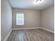 Bright bedroom featuring durable laminate flooring, fresh paint, and a large window at 2646 Rockcliff Road Se, Atlanta, GA 30316