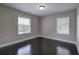 Neutral bedroom with wood floor, white trim, and two large windows with plenty of natural light at 2646 Rockcliff Road Se, Atlanta, GA 30316