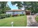 Traditional home with a lush lawn, mature trees, and a carport at 2646 Rockcliff Road Se, Atlanta, GA 30316