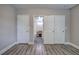 Hallway featuring durable laminate flooring, neutral paint, and access to nearby bathroom at 2646 Rockcliff Road Se, Atlanta, GA 30316