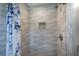 Close up of the modern shower showcasing textured tile and built-in niche at 2646 Rockcliff Road Se, Atlanta, GA 30316