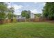 Expansive backyard featuring a large grassy lawn and a wood fence boundary at 5515 Pennybrook Trl, Stone Mountain, GA 30087