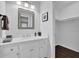 Bathroom featuring white cabinets, a mirror and a small decor for a simple, yet elegant design at 5515 Pennybrook Trl, Stone Mountain, GA 30087
