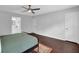 Bedroom with hardwood floors that are light gray walls and a black ceiling fan, offering a bright, airy space at 5515 Pennybrook Trl, Stone Mountain, GA 30087