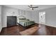 Bedroom featuring dark hardwood floors and a black metal bed frame, providing a cozy and stylish space at 5515 Pennybrook Trl, Stone Mountain, GA 30087